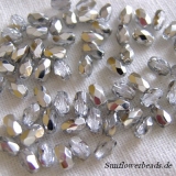 50 Stück - Glasschliffperlen oval - crystal half silver